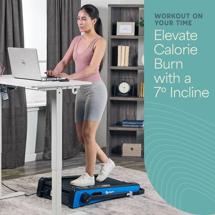 Woman walking on the PacerMini treadmill at a standing desk, with text reading Workout On Your Time, Elevate Calorie Burn With a 7 Degree Incline.