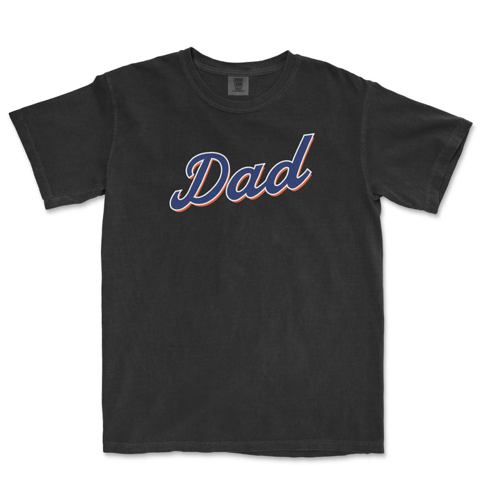 Black T-shirt with the word "Dad" in bold, cursive font, featuring blue and orange outline, celebrating Queens baseball dads.