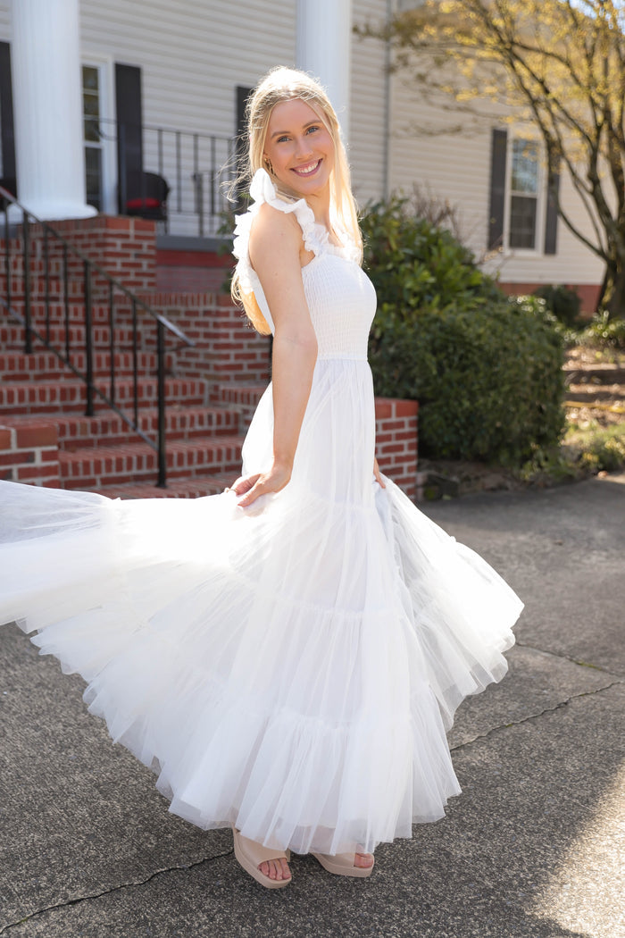 A real-life model showing off a white tulle dress, perfect for women who want something light and flowy, but still elegant