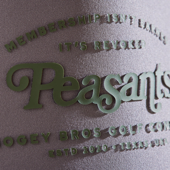 Close-up of the Revoked - Unstructured Flat Bill Hat - Snapback features textured performance material and raised green text: "Membership isn’t earned, it’s revoked. Peasants" in script, plus Bogey Bros Golf Co., Estd 2020, Texas, USA.