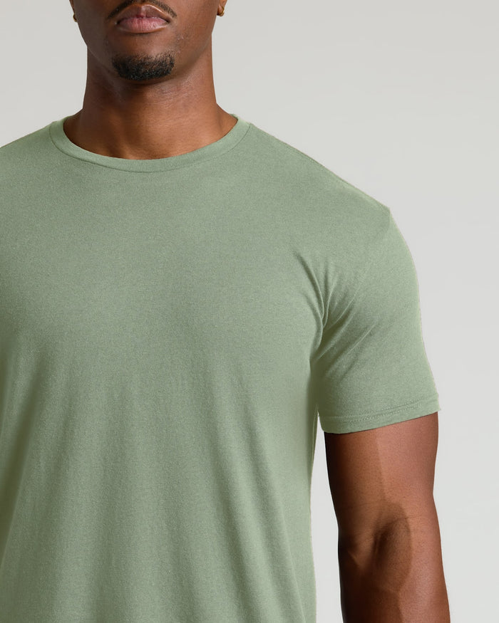Man wearing a plain green t-shirt against a neutral background