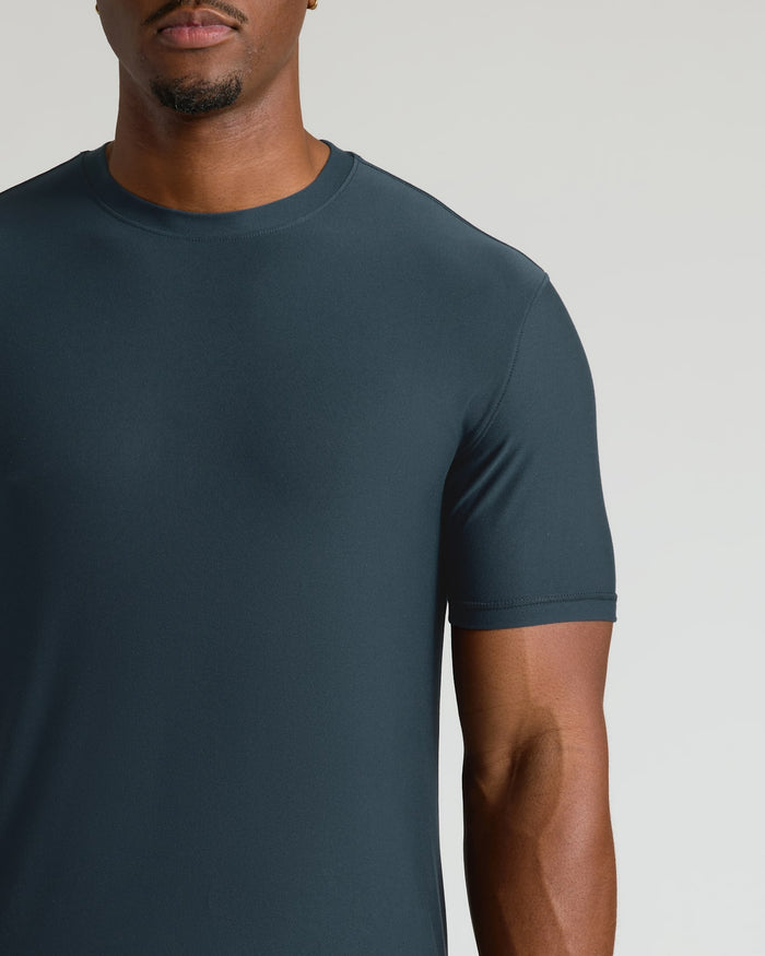 Man wearing a dark gray t-shirt against a plain background
