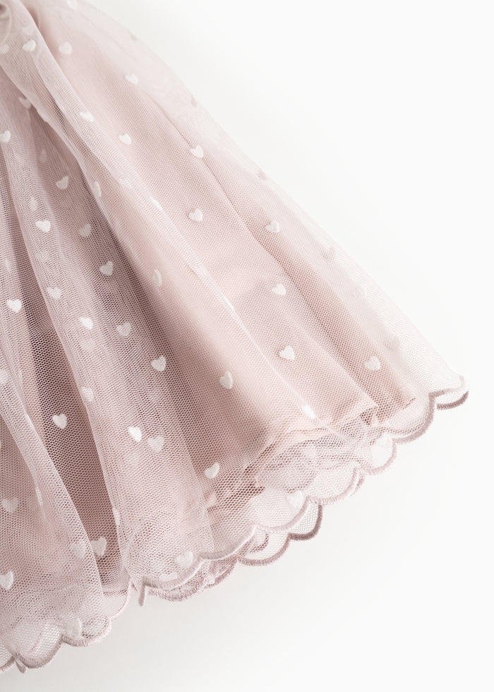 Pink skirt with heart pattern and bacon edge at the bottom.