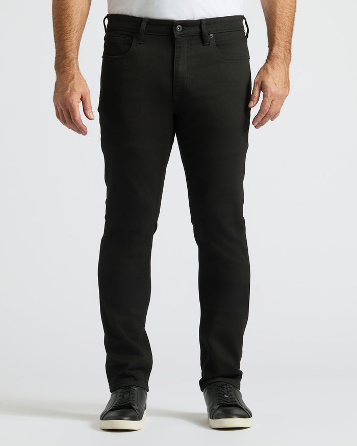 Person wearing black jeans on a white background