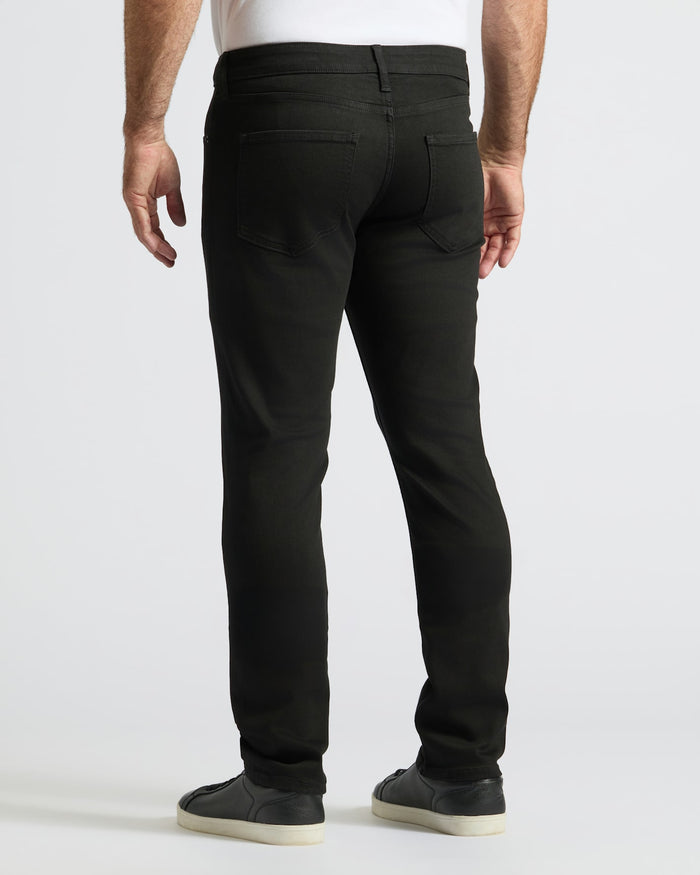 Black Wash Straight Comfort Stretch Jeans modeled with white shirt and sneakers.