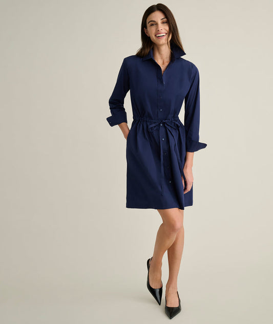 Model is wearing UNTUCKit Taylor dress in navy.