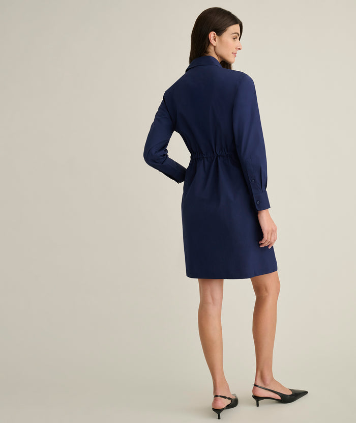 Model is wearing UNTUCKit Taylor dress in navy.