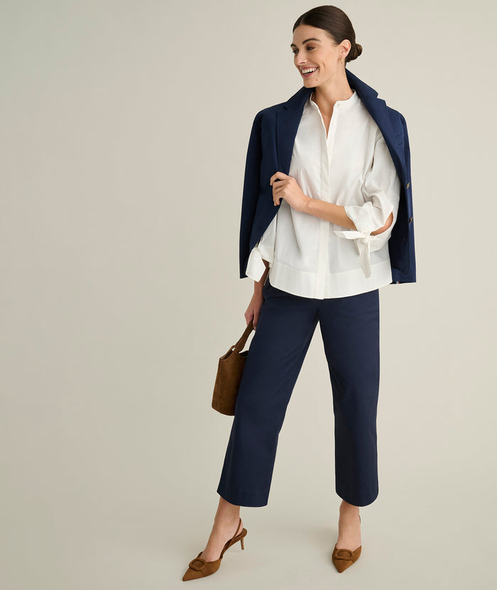Model is wearing UNTUCKit Ava trousers in navy.