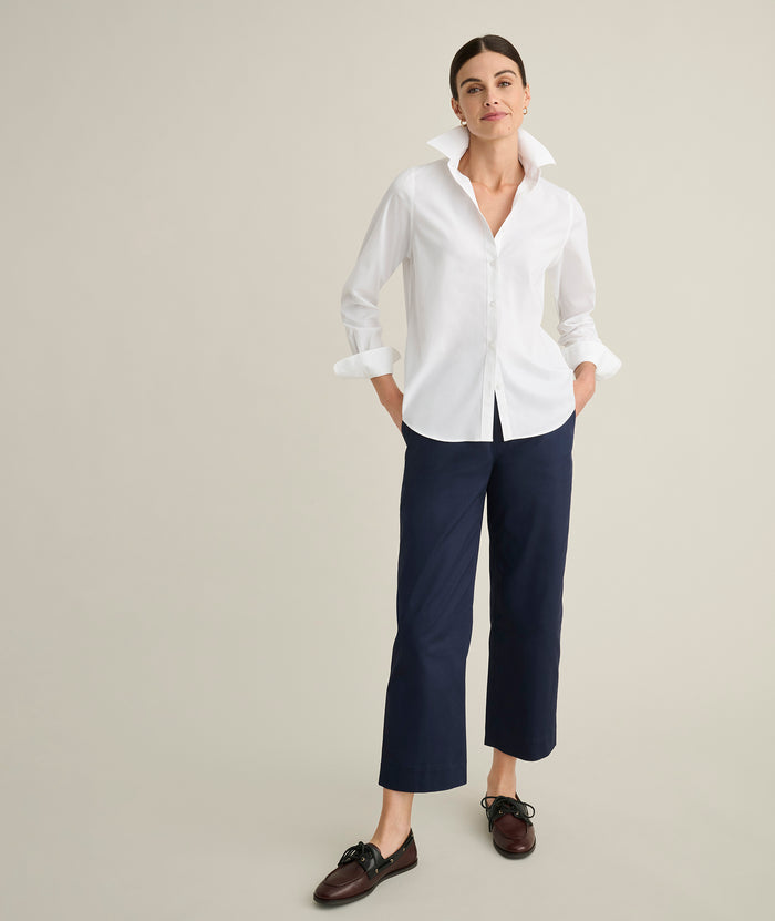 Model is wearing UNTUCKit Ava trousers in navy.