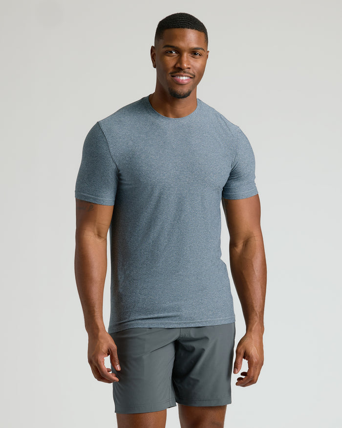 Man wearing Heather Navy Tall Active Crew Neck 2.0 and athletic shorts.