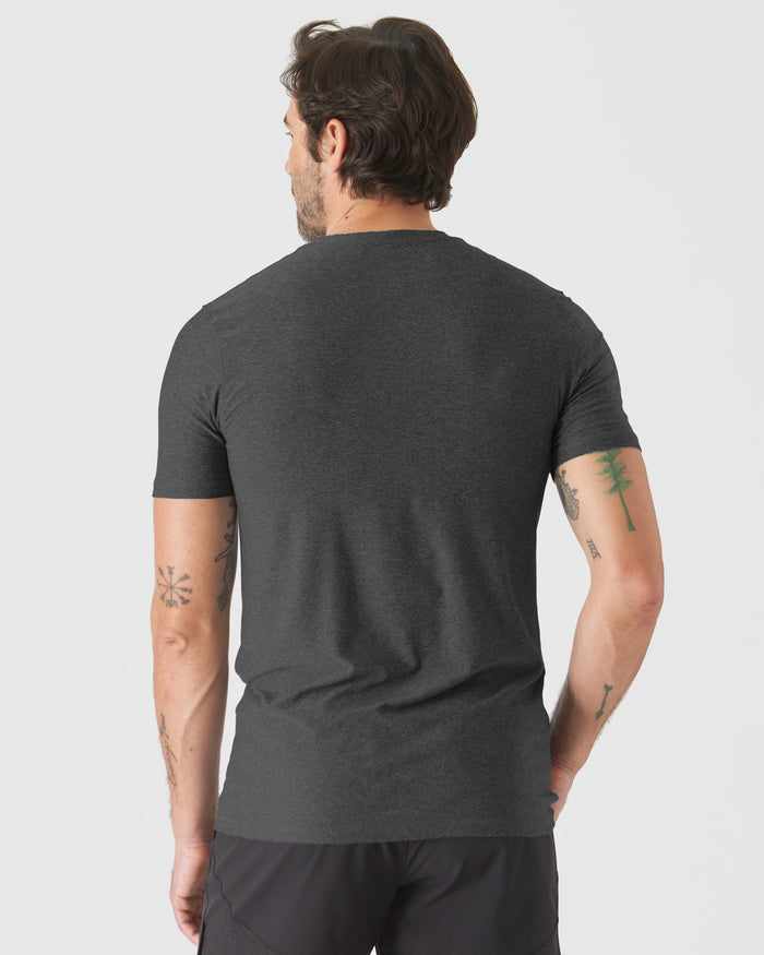 Man wearing Neutral Short Sleeve Tall Active Crew, showcasing tattoos.