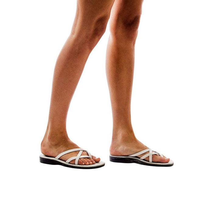 Model wearing Tamar white, handmade leather slide sandals