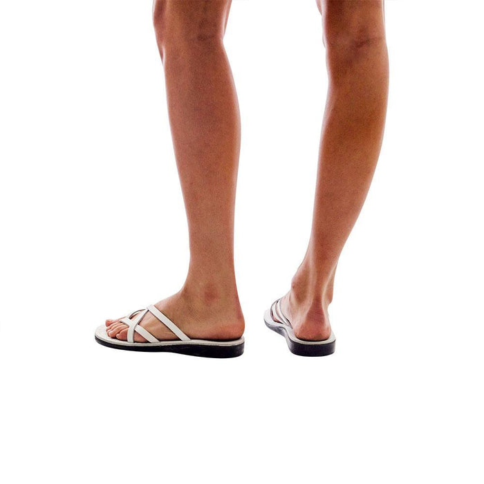 Model wearing Tamar white, handmade leather slide sandals