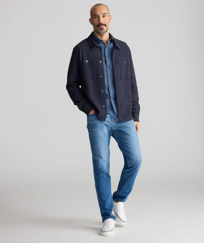 Model is wearing UNTUCKit denim in rinse.