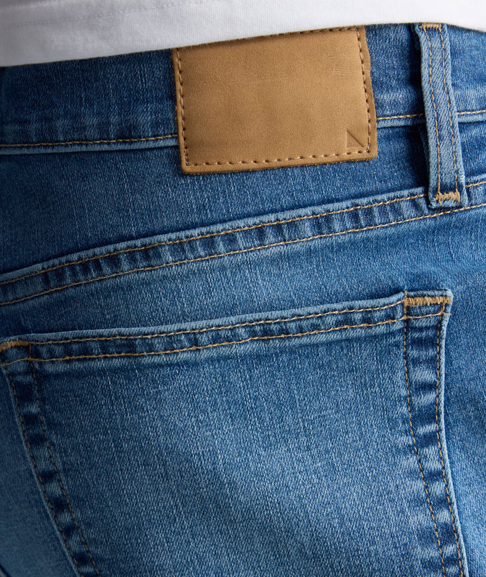 Model is wearing UNTUCKit denim in rinse.