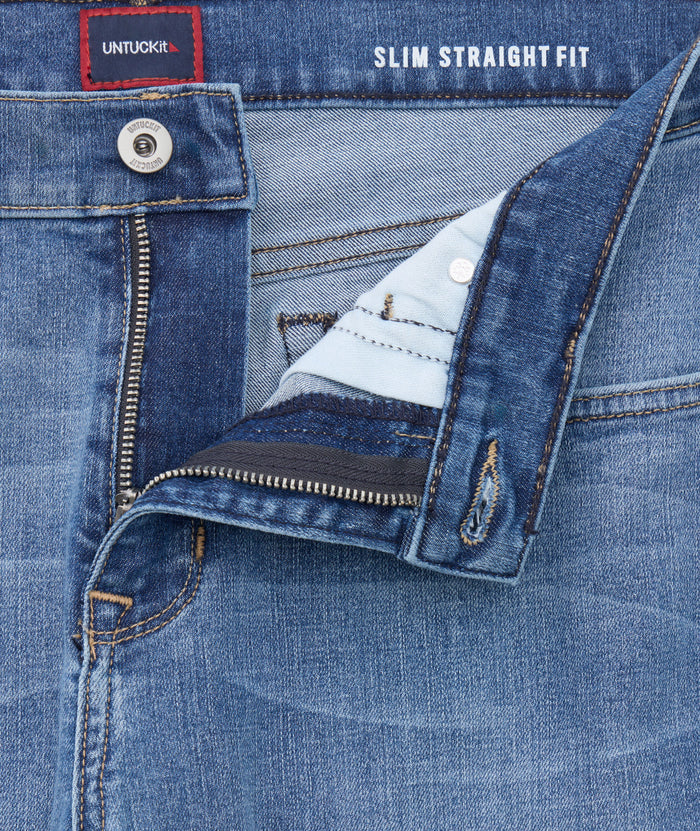 Model is wearing UNTUCKit denim in rinse.