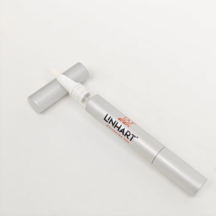 Silver cosmetic pen with a brush applicator and cap, labeled Whitening Pen | LINHART, designed for targeted skincare treatment.