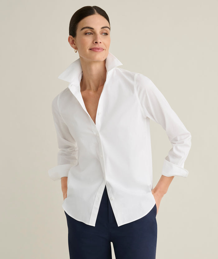 Model is wearing UNTUCKit Isabella shit in white.