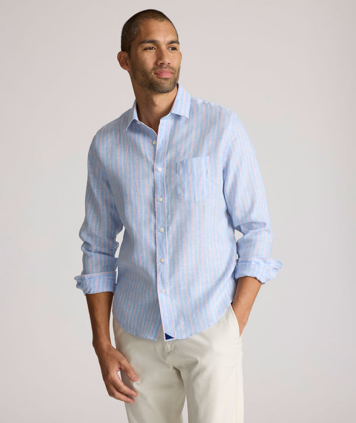 Model is wearing UNTUCKit Boyd  light blue stripe linen shirt.