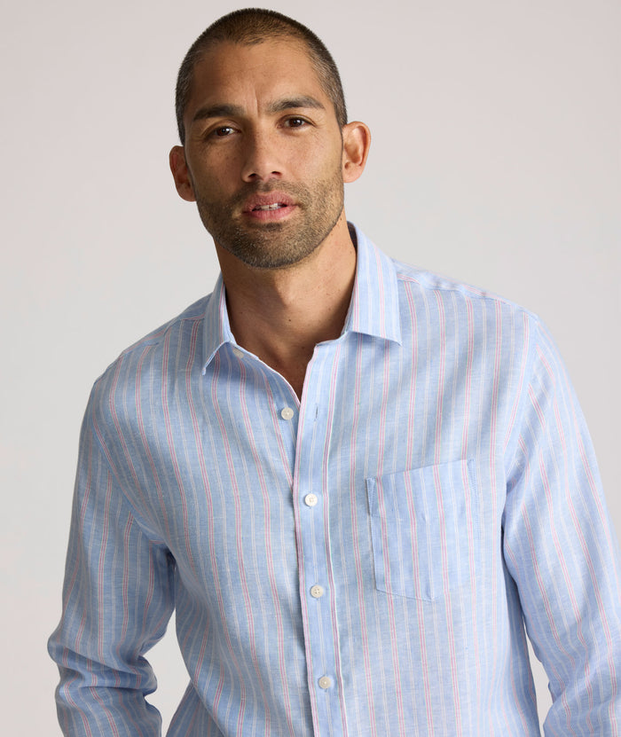 Model is wearing UNTUCKit Boyd  light blue stripe linen shirt.