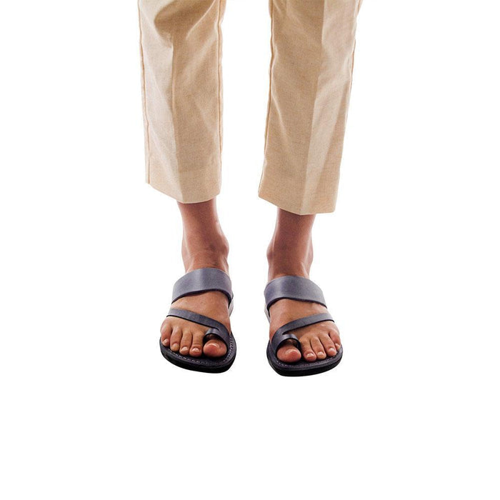 Model wearing Zohar gray, handmade leather slide sandals with toe loop